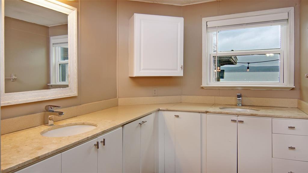 1059 Airport Road Graford, TX 76449 - Photo 17 of 35 a bathroom with a granite countertop sink and a mirror