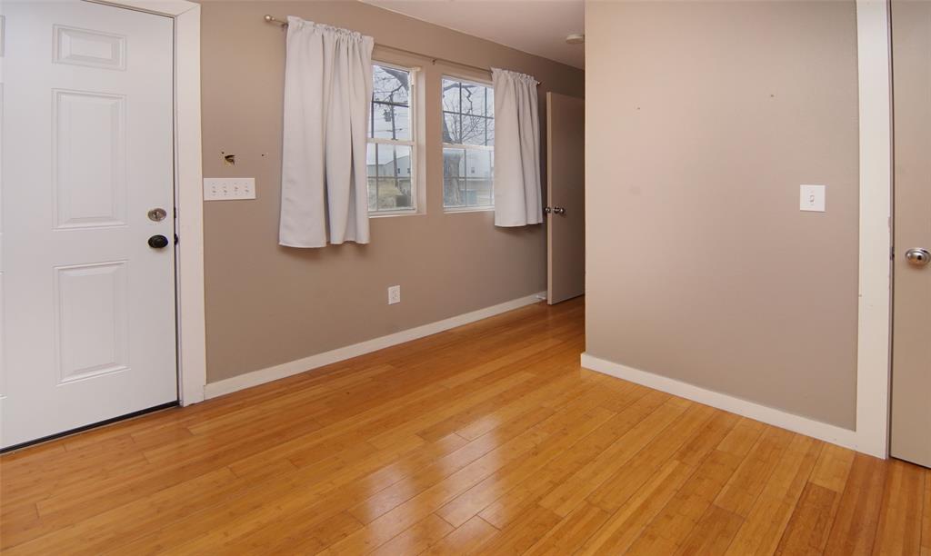 1059 Airport Road Graford, TX 76449 - Photo 20 of 35 an empty room with wooden floor and windows