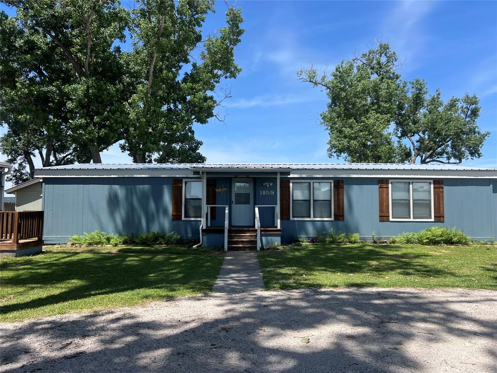 1059 Airport Road Graford, TX 76449 - Photo 2 of 35 a front view of a house with a yard