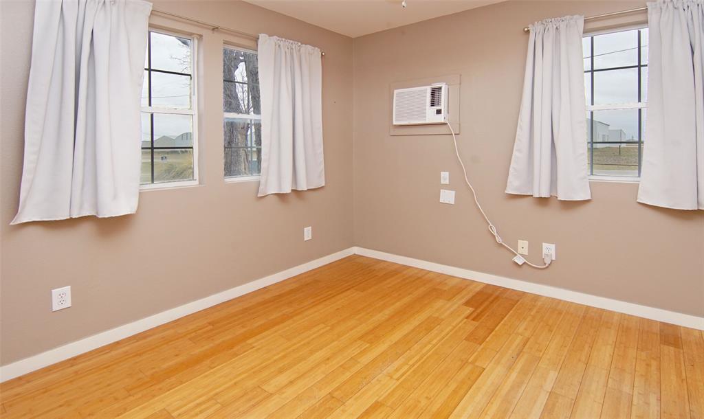 1059 Airport Road Graford, TX 76449 - Photo 22 of 35 a view of a room with wooden floor and windows