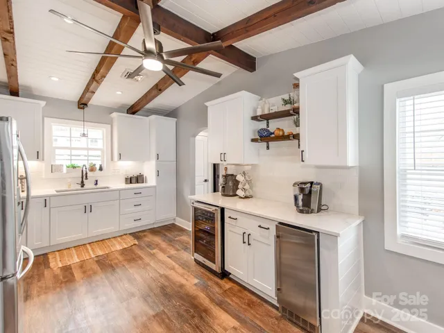 a kitchen with white cabinets and stainless steel appliances