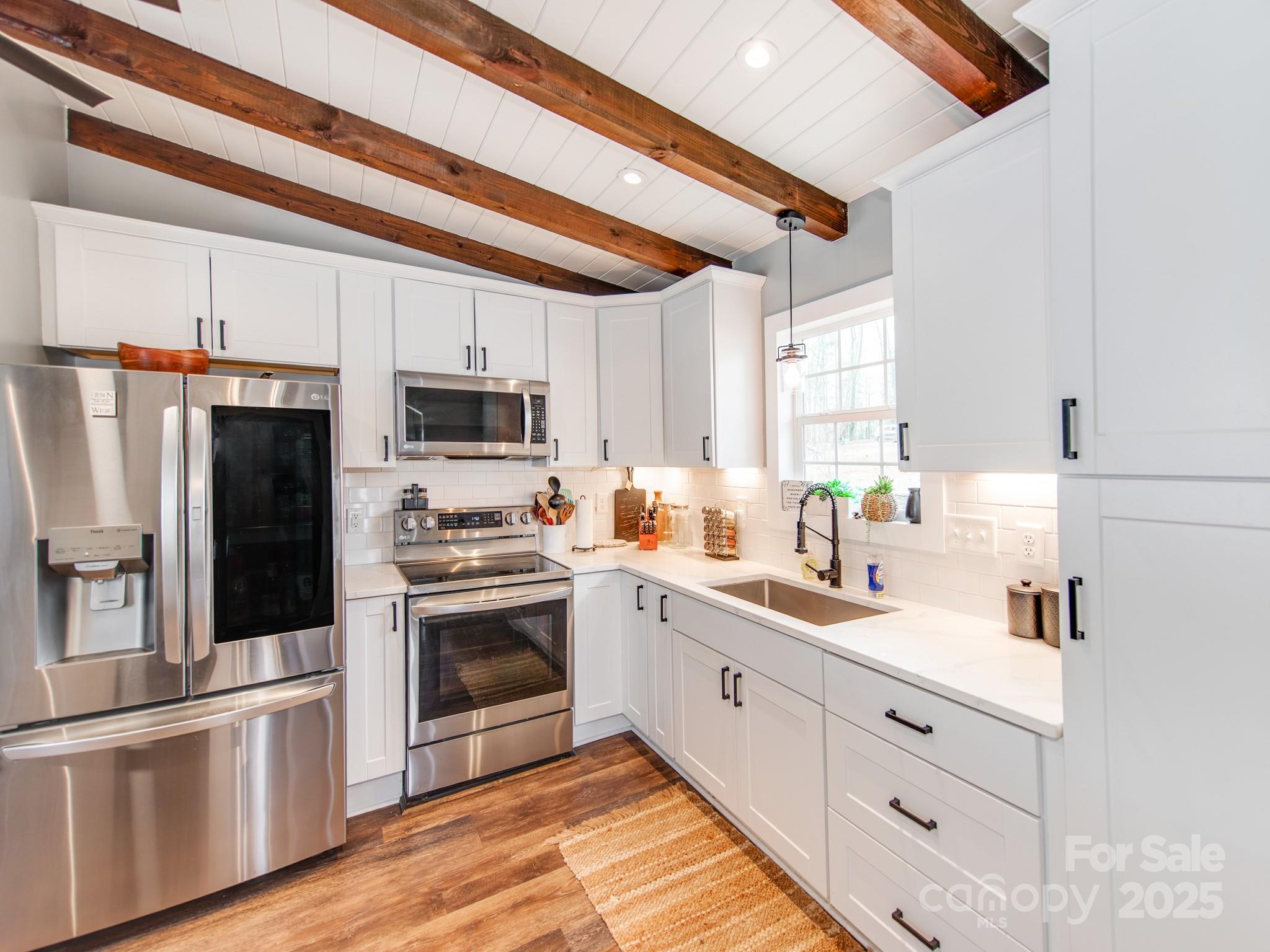 6788 Bucleigh Road Lake Wylie, SC 29710 - Photo 16 of 45 a kitchen with white cabinets and stainless steel appliances