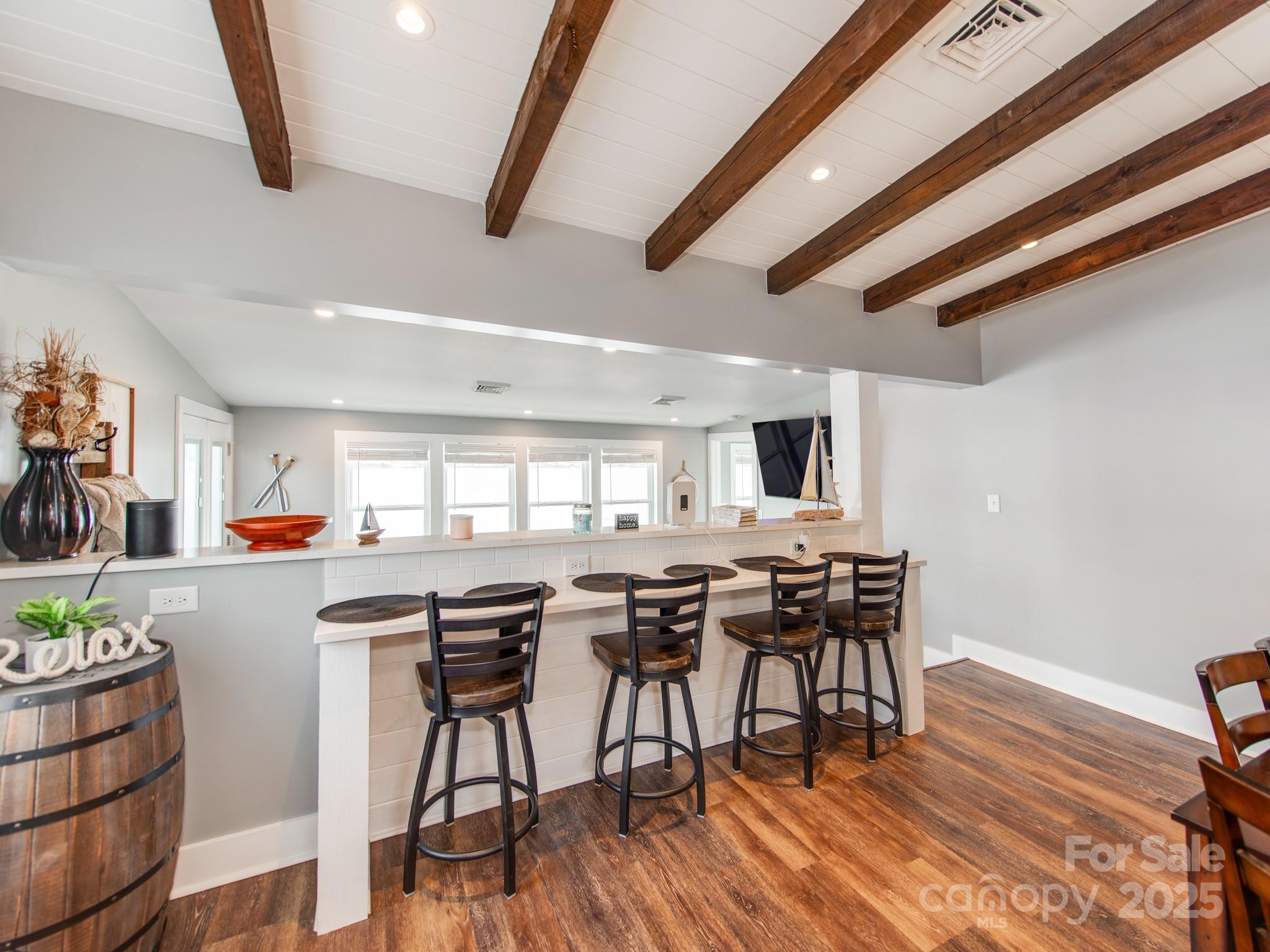 6788 Bucleigh Road Lake Wylie, SC 29710 - Photo 17 of 45 a view of a dining room with furniture and wooden floor