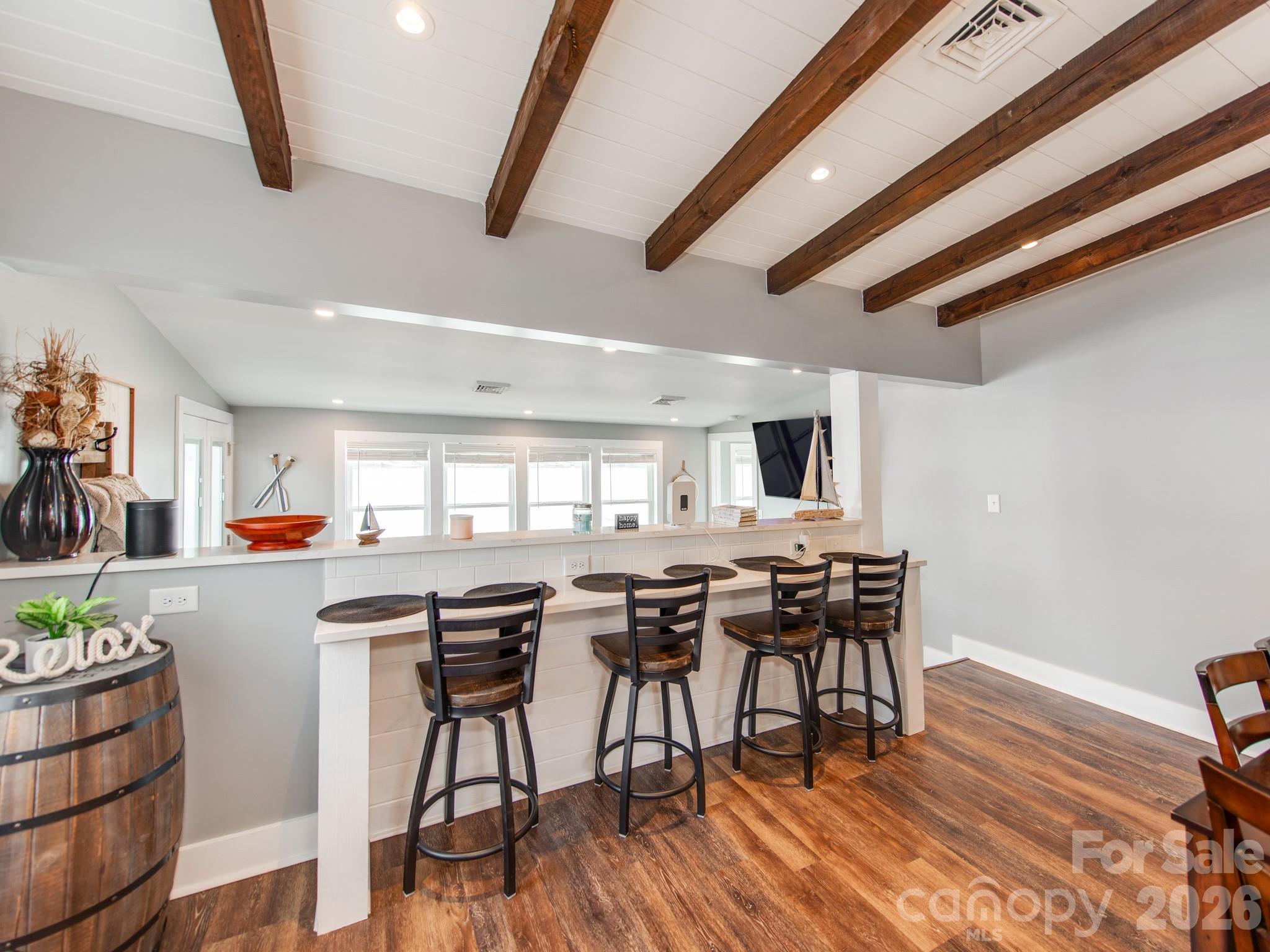6788 Bucleigh Road Lake Wylie, SC 29710 - Photo 18 of 45 a view of a dining room with furniture and wooden floor