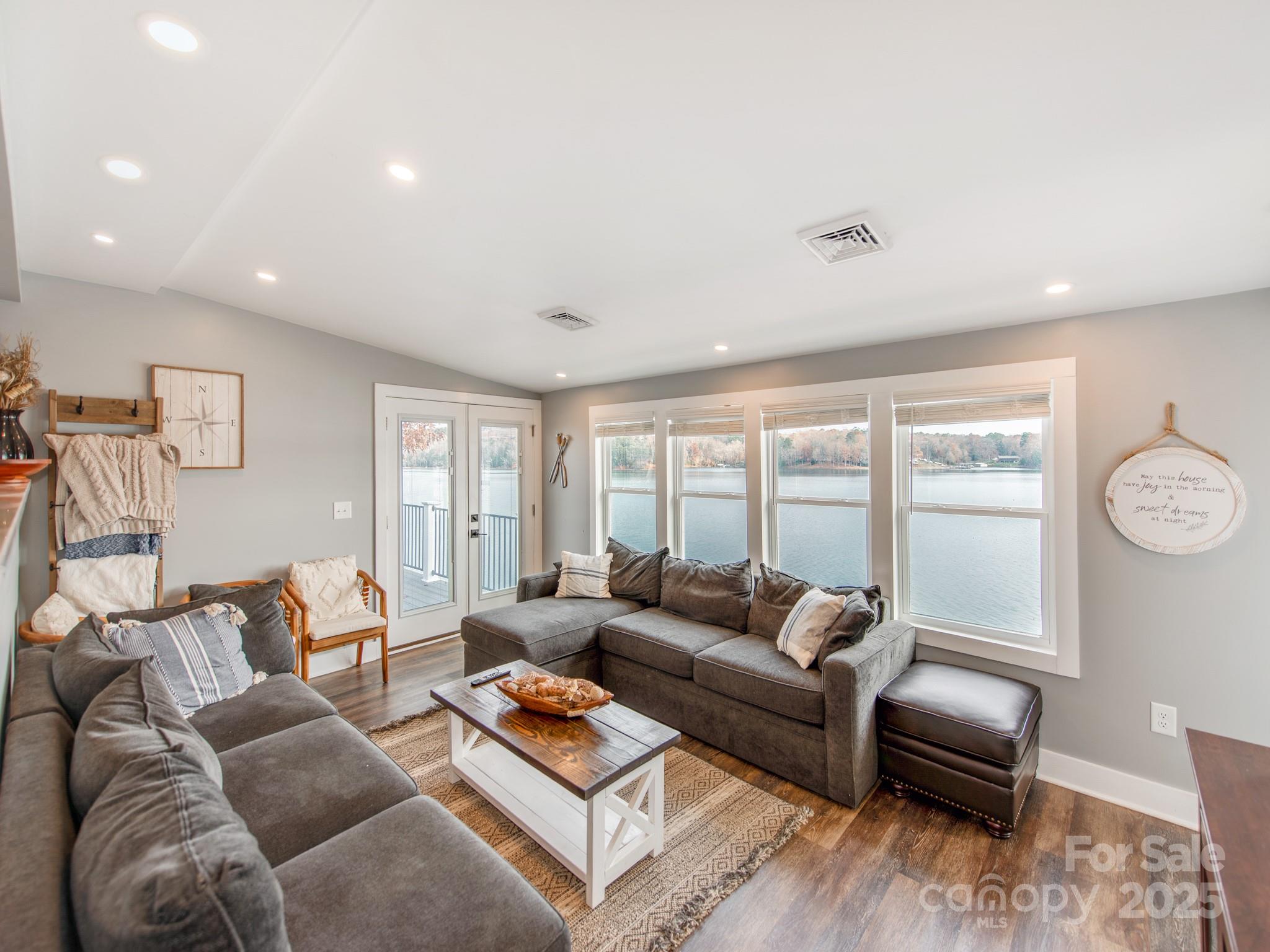 6788 Bucleigh Road Lake Wylie, SC 29710 - Photo 18 of 45 a living room with furniture and a large window