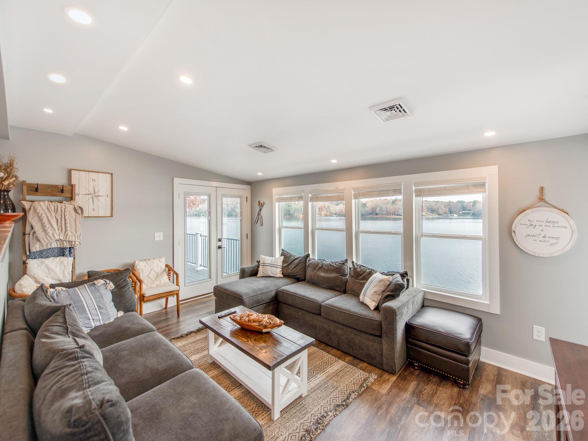6788 Bucleigh Road Lake Wylie, SC 29710 - Photo 19 of 45 a living room with furniture and a large window