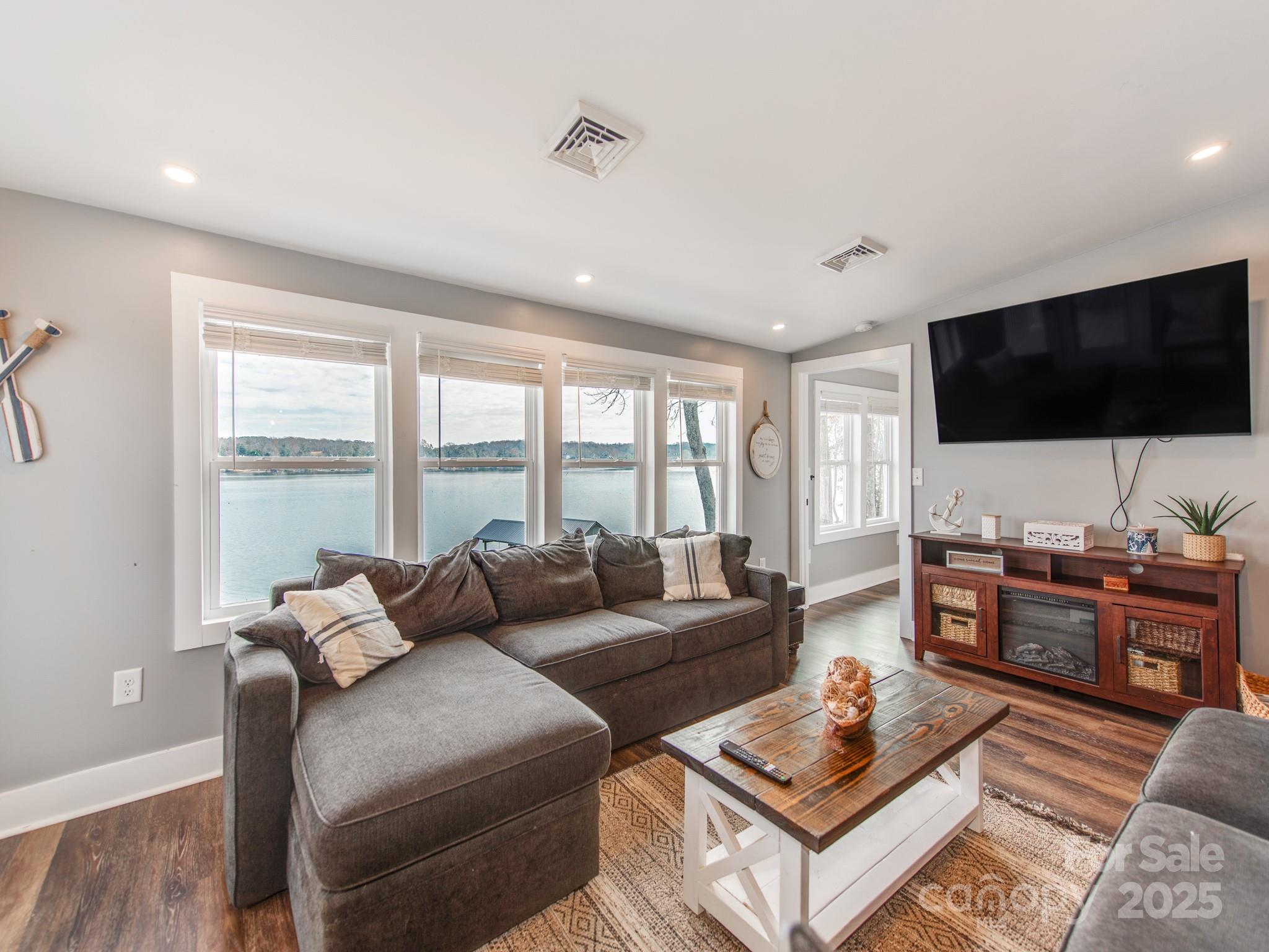 6788 Bucleigh Road Lake Wylie, SC 29710 - Photo 21 of 45 a living room with furniture and a flat screen tv