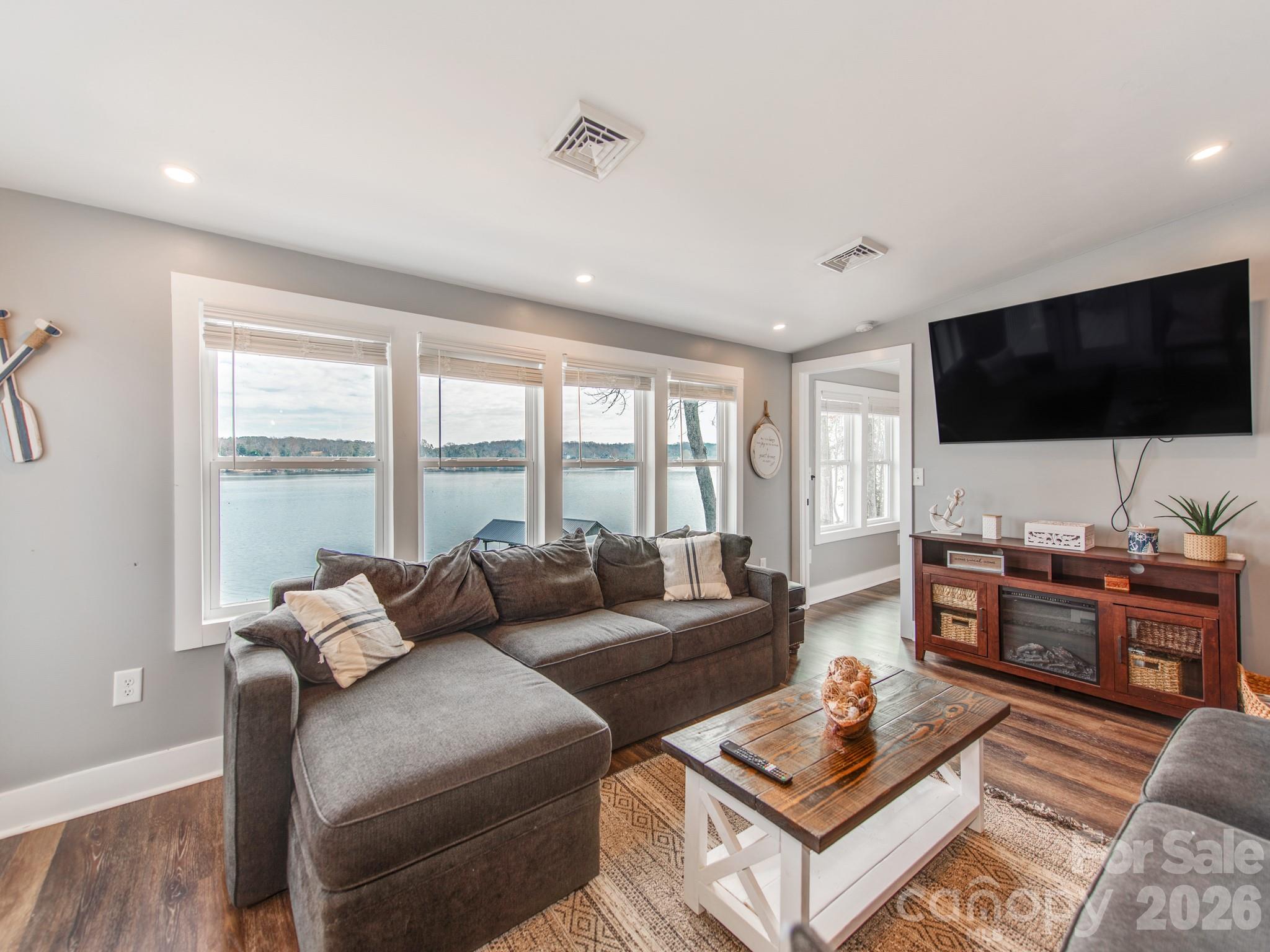 6788 Bucleigh Road Lake Wylie, SC 29710 - Photo 22 of 45 a living room with furniture and a flat screen tv