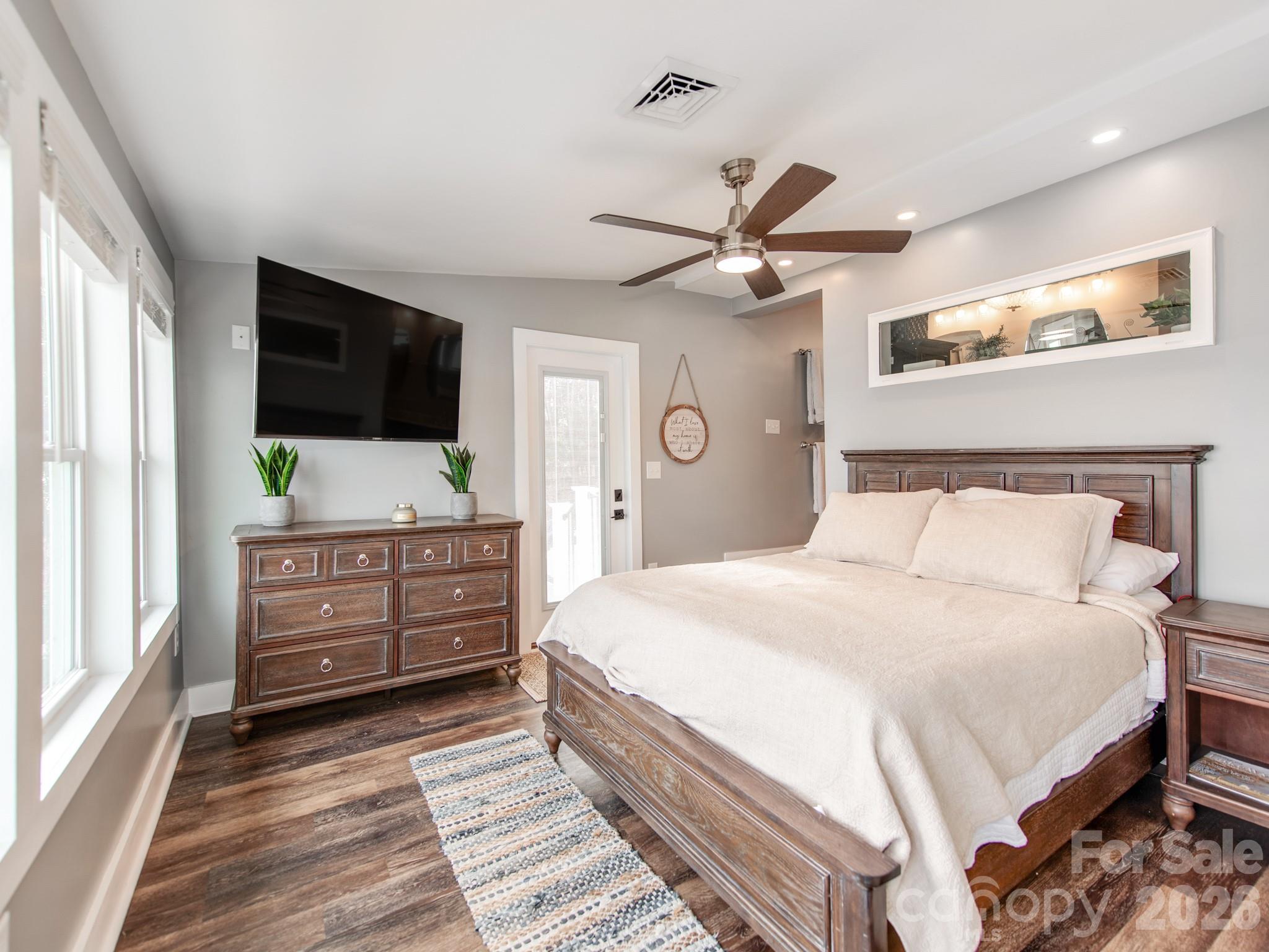 6788 Bucleigh Road Lake Wylie, SC 29710 - Photo 23 of 45 a bedroom with a bed and a flat screen tv