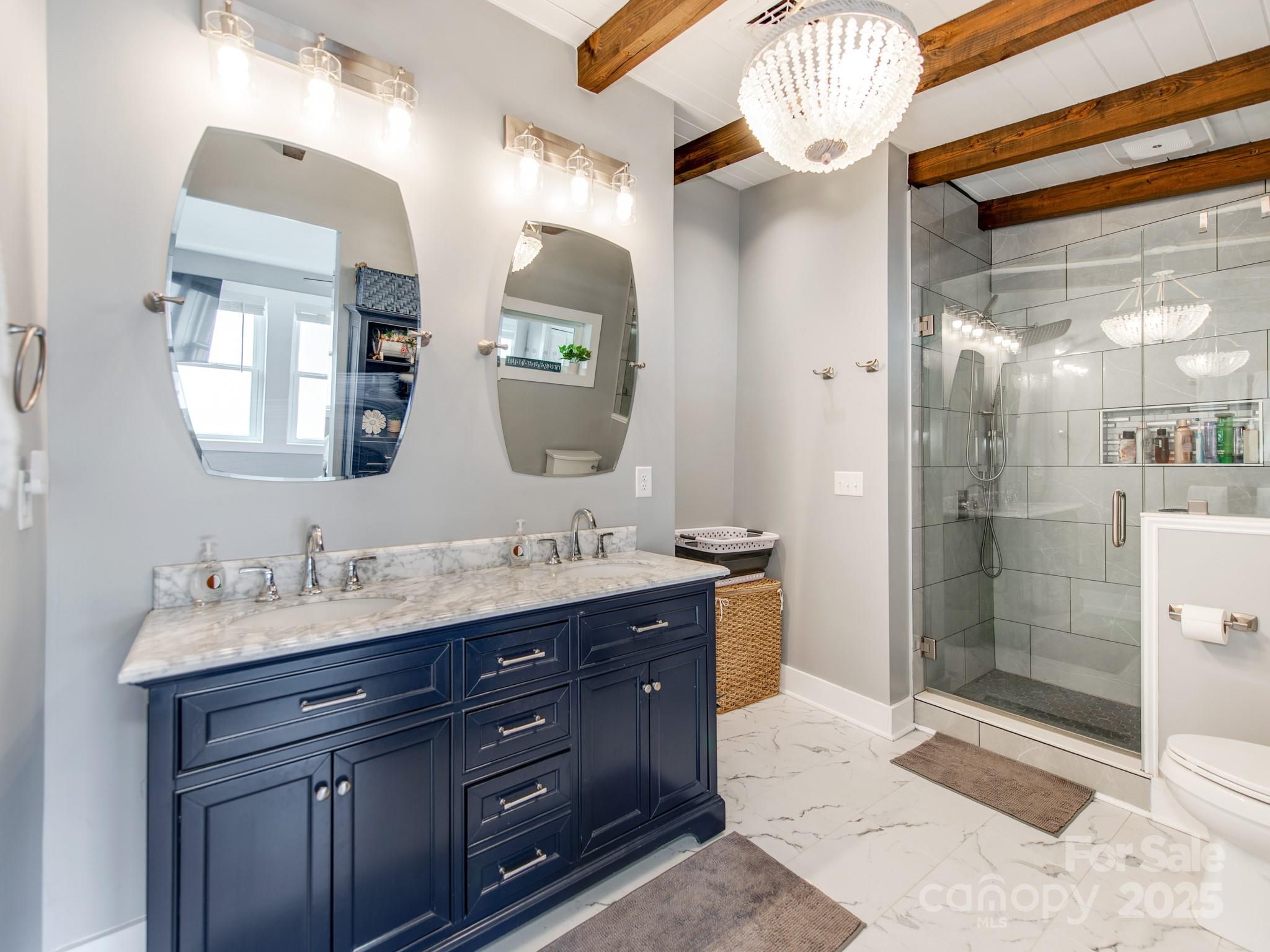 6788 Bucleigh Road Lake Wylie, SC 29710 - Photo 24 of 45 a spacious bathroom with a granite countertop sink mirror and shower