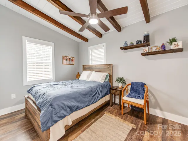 a bed sitting in a bedroom next to a window