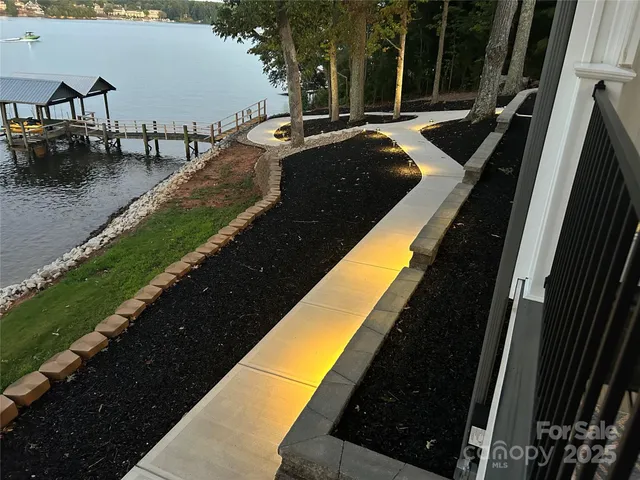a view of swimming pool with outdoor seating and lake view