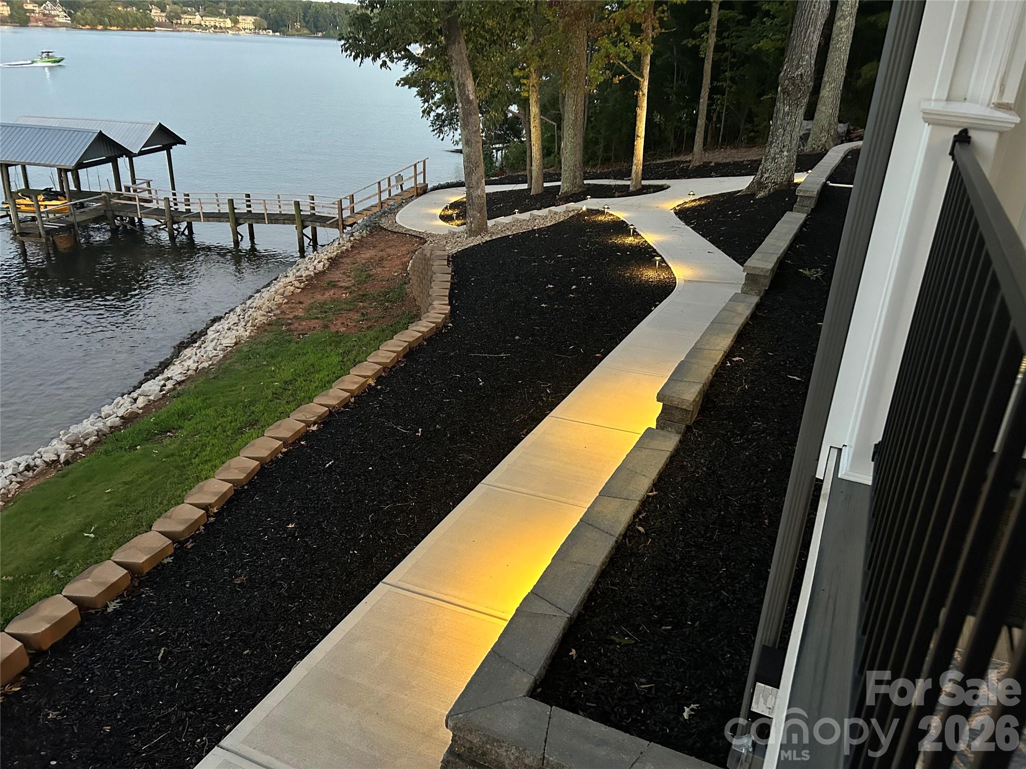 6788 Bucleigh Road Lake Wylie, SC 29710 - Photo 3 of 45 a view of swimming pool with outdoor seating and lake view