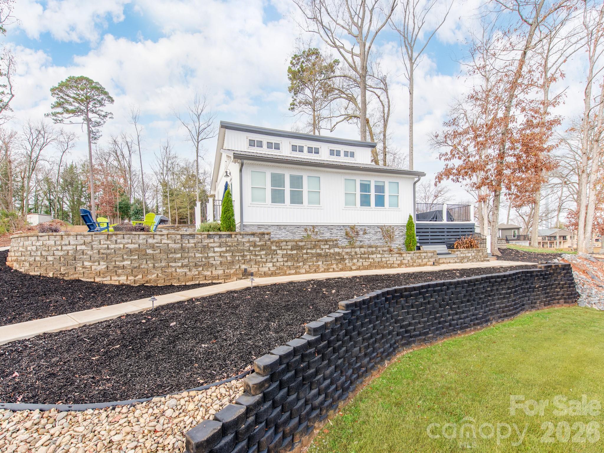 6788 Bucleigh Road Lake Wylie, SC 29710 - Photo 40 of 45 a view of a house with a swimming pool