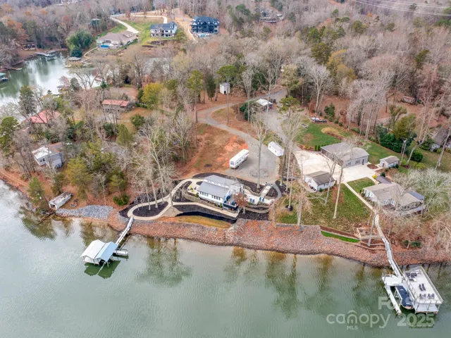 an aerial view of a swimming pool with a yard