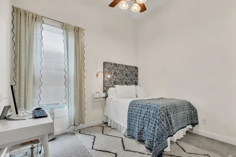 a bedroom with a bed and a mirror