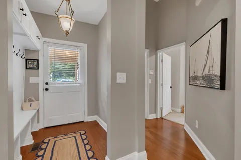 a view of a hallway view with furniture and wooden floor