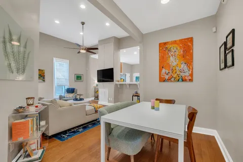 a view of a dining room with furniture and a chandelier