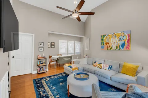 a living room with furniture and a wooden floor