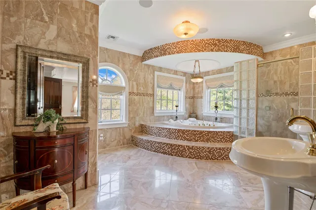 a spacious bathroom with a tub sink and mirror