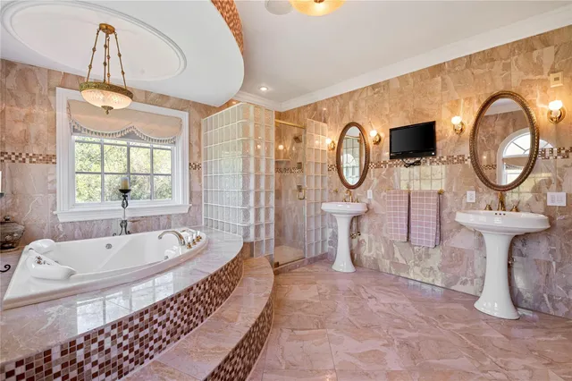 a spacious bathroom with a double vanity sink a mirror and a bathtub