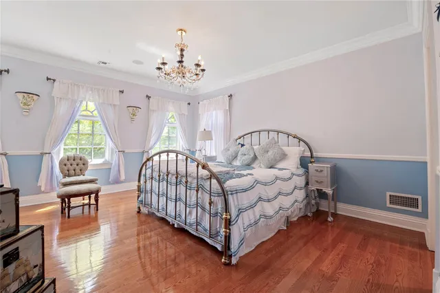 a living room with furniture chandelier and a window