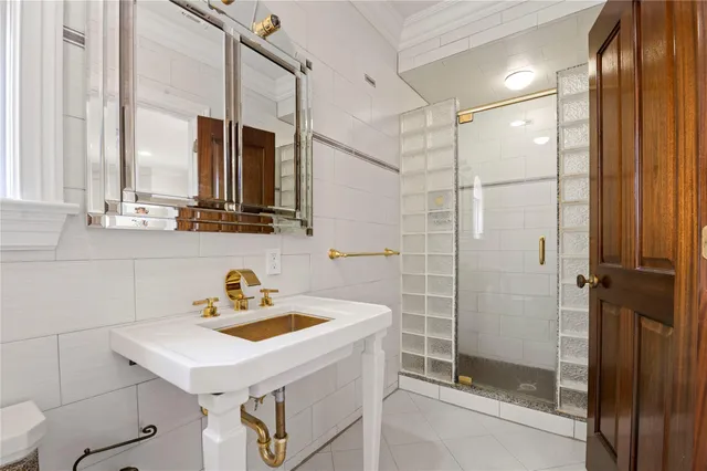 a bathroom with a sink a mirror and a shower