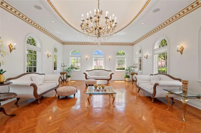 a living room with furniture or chandelier and a large window