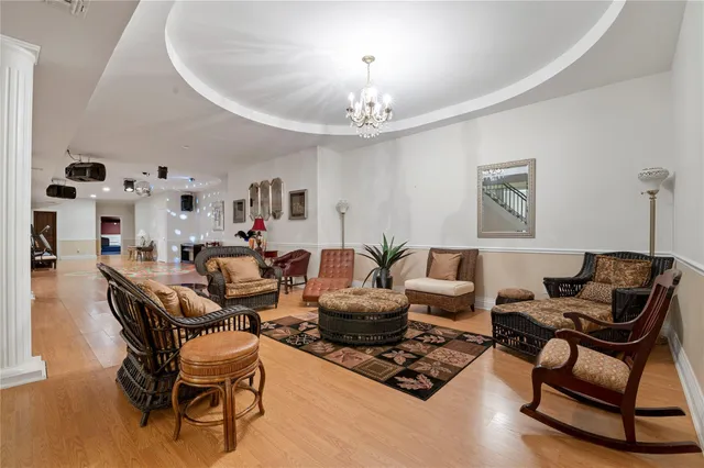 a living room with furniture and a chandelier