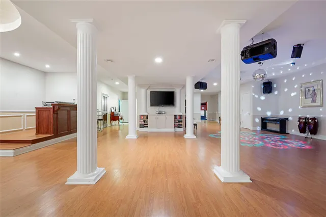 a living room with stainless steel appliances furniture and a flat screen tv