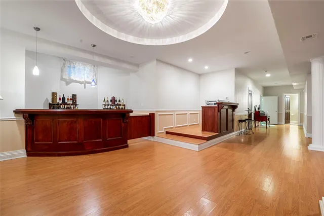 a living room with kitchen furniture and a chandelier