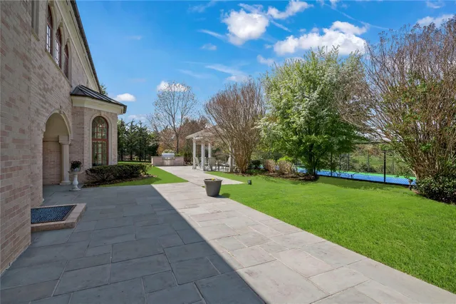 a view of a garden with large trees
