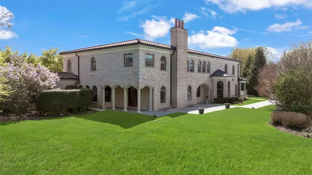 a view of a house with a yard and sitting area