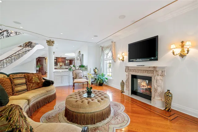 a living room with furniture a fireplace and a flat screen tv