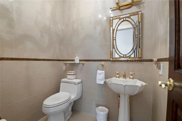 a bathroom with a sink a mirror and toilet