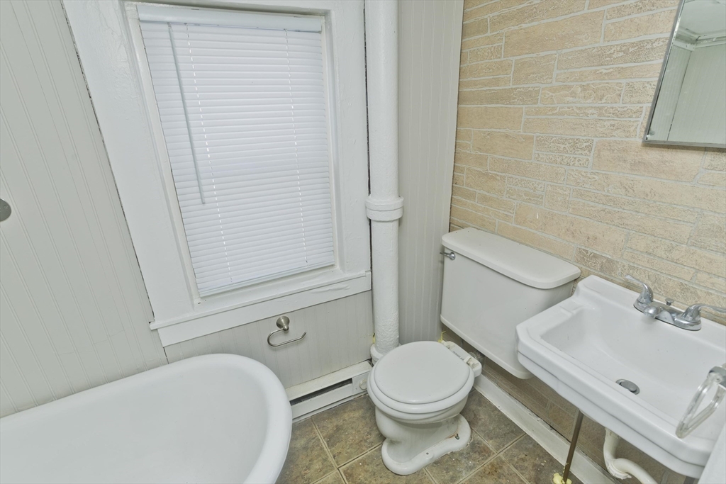 98 Ellsworth Avenue Springfield, MA 01118 - Photo 11 of 17 a white toilet sitting next to a bathroom sink