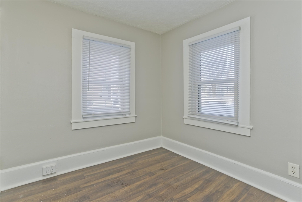98 Ellsworth Avenue Springfield, MA 01118 - Photo 13 of 17 a view of an empty room with wooden floor and a window