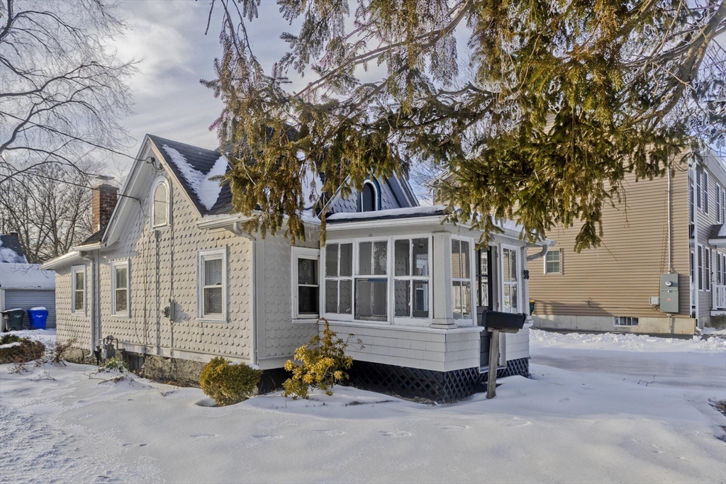 98 Ellsworth Avenue Springfield, MA 01118 - Photo 2 of 17 a front view of a house with a garden and trees