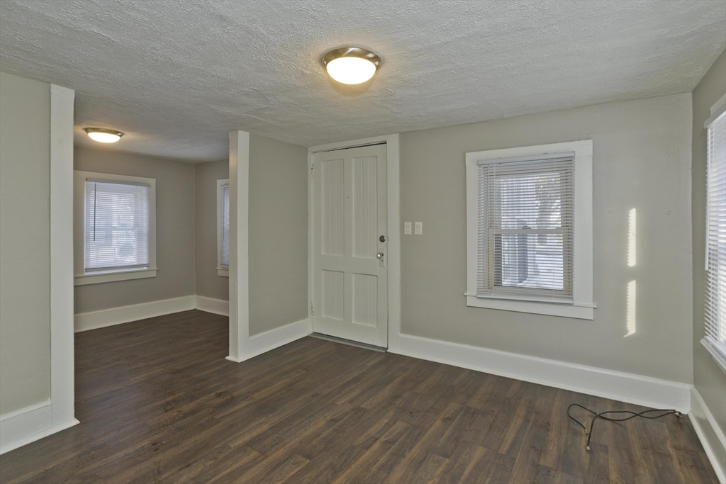 98 Ellsworth Avenue Springfield, MA 01118 - Photo 6 of 17 an empty room with wooden floor and windows