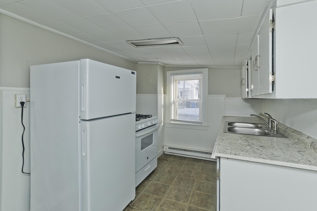 98 Ellsworth Avenue Springfield, MA 01118 - Photo 7 of 17 a white refrigerator freezer sitting inside of a kitchen
