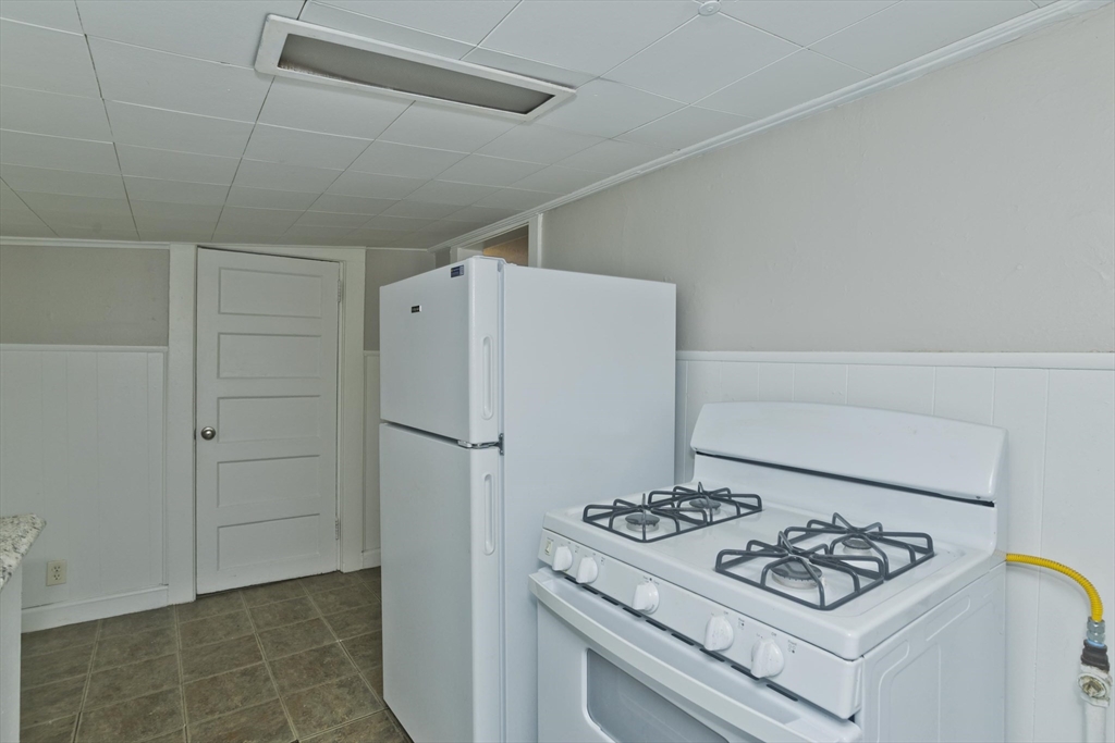 98 Ellsworth Avenue Springfield, MA 01118 - Photo 8 of 17 a white refrigerator freezer and a stove sitting inside of a kitchen