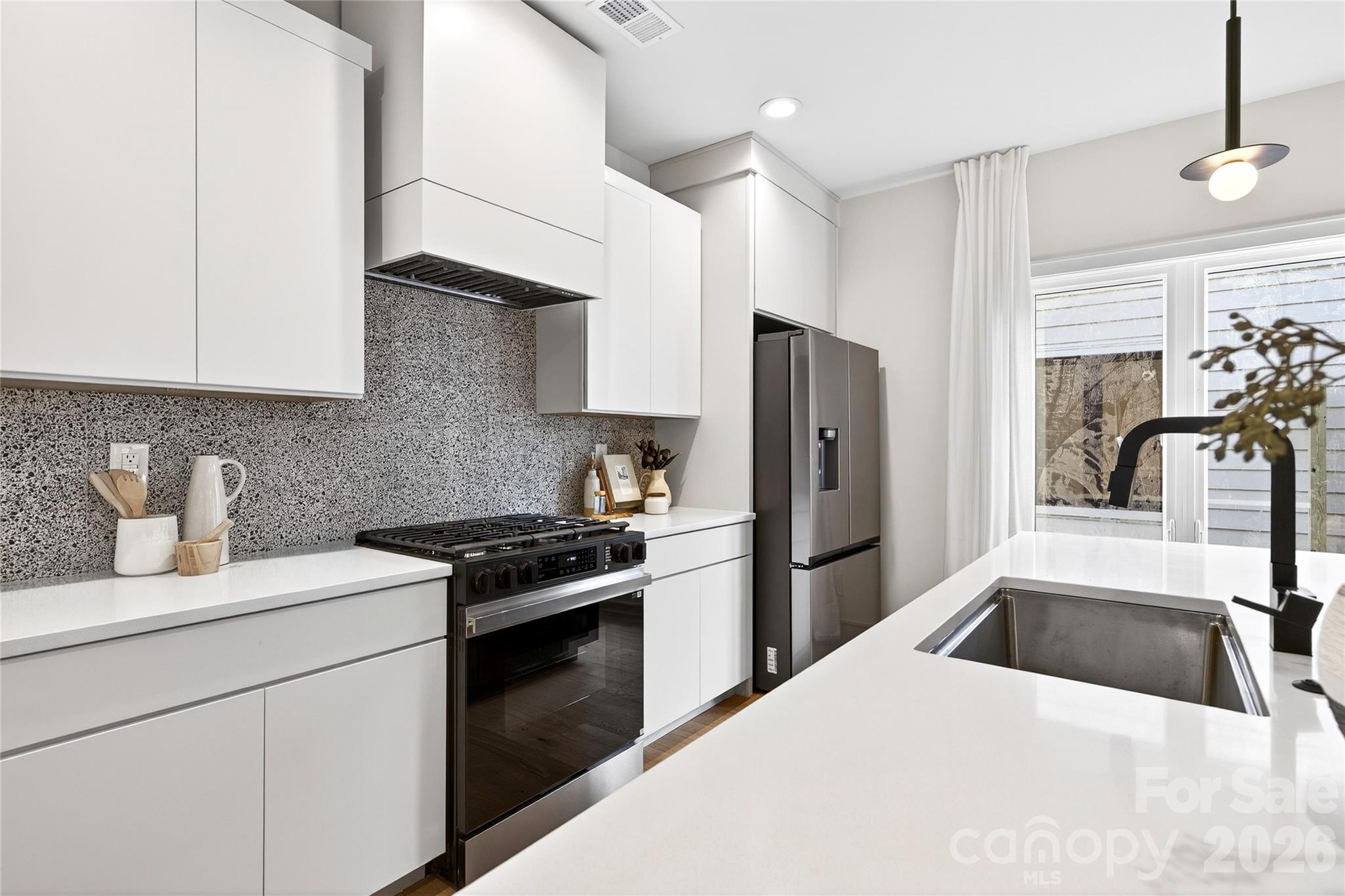 2713 Ruby Street Charlotte, NC 28208 - Photo 13 of 31 a kitchen with a stove a refrigerator and a sink