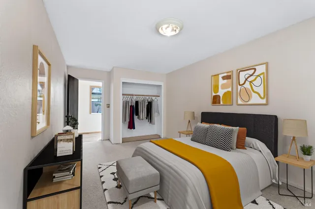 a bedroom with beds and painting on the wall