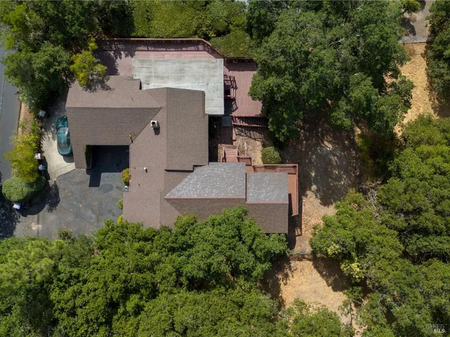 an aerial view of a house with a yard and a fountain