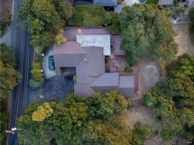 an aerial view of a house with a yard and garden
