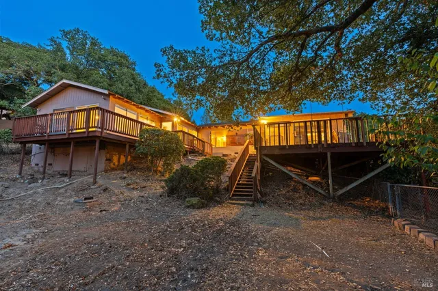 a view of a small house with a yard