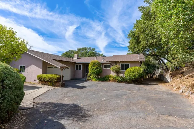 front view of a house with a bench