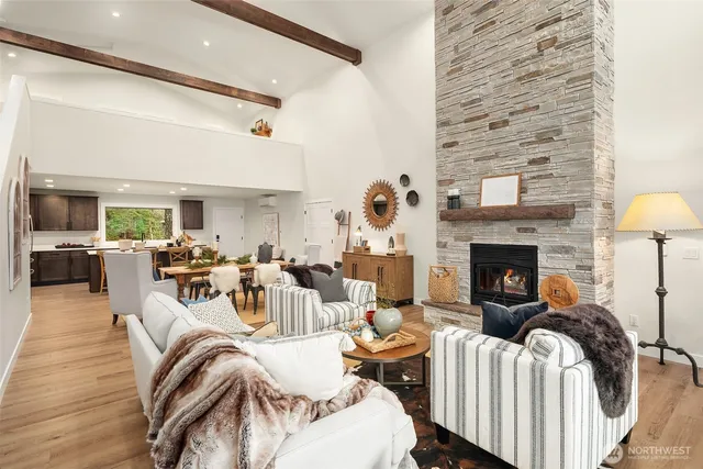a living room with furniture fireplace and a table