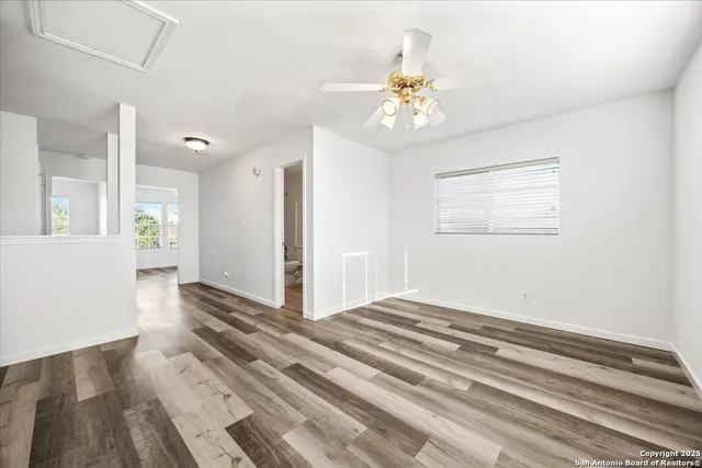 a spacious bedroom with a bed and a window