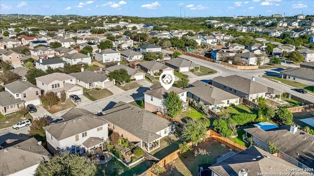 an aerial view of residential houses with outdoor space